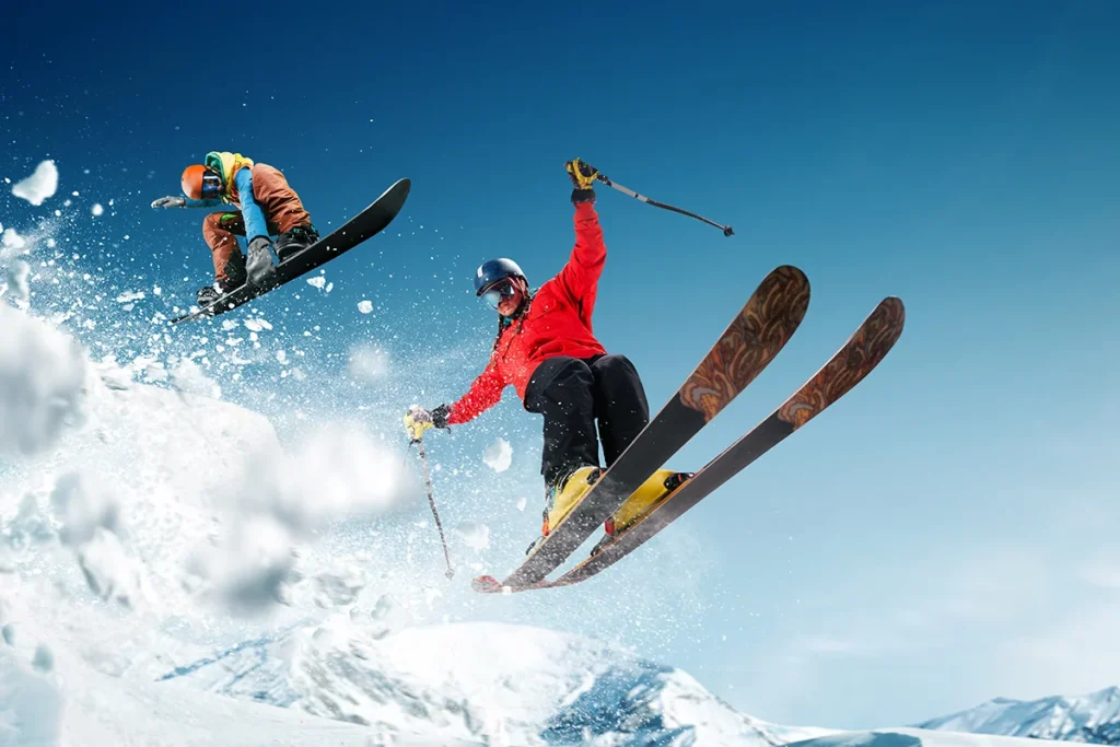 Winter sports are a great way to stay fit A skier and snowboarder both catch air