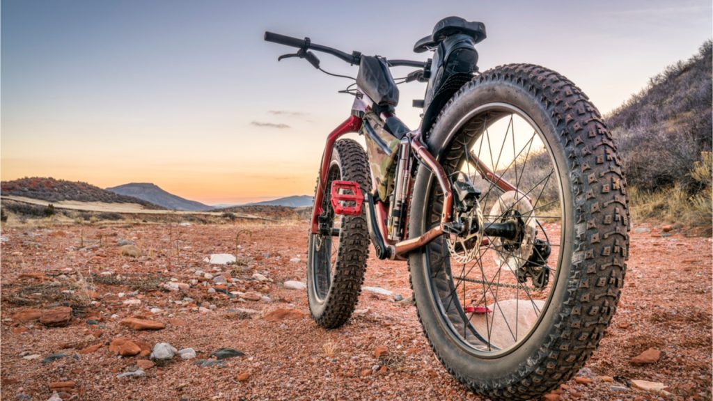 Red bicycle with thick wheels from Fat Bike rental in a desert