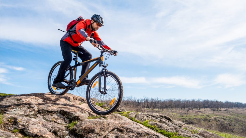  A bike from mountain bike rental on the background of the mountains and green grass